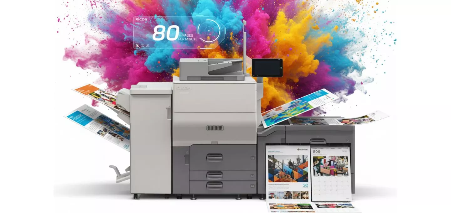  A colorful, vibrant image of a Ricoh printer against a white background. It's surrounded by an explosion of colorful powder—magenta, yellow, and cyan—that is reminiscent of CMYK colors. The printer has multiple sheets of paper bursting out from its sides, including a calendar and a brochure, all in full color. A futuristic blue graphic hovers above the printer, displaying "80 pages per minute" and the Ricoh logo.